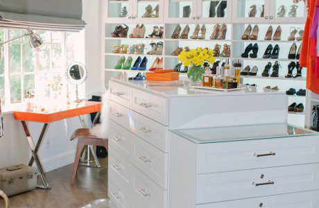 Walk in Closet with High Gloss White Cabinets Stand Alone Dresser and Orange Vanity Desk