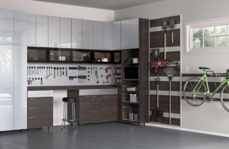 Garage Organization in high gloss white and matte dark brown storage cabinets with work space and tool racks