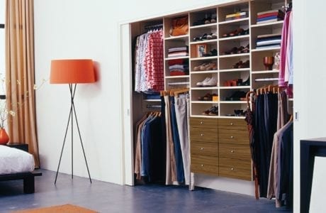 Reach in Closet with Closet Rods and Brown Drawers and White Shelving