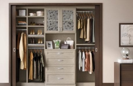 Reach in Closet with Glass Fronted Display Cabinet and Light Brown Shelves Drawers and Closet Rods