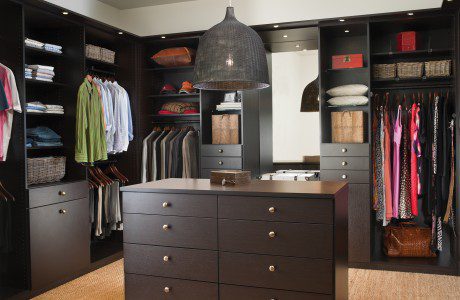 Dark Brown Walk in Closet with Cabinets Shelves Vanity Mirror and Built in Lighting