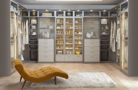 Light Grey Walk in Closet with Shelving Closet Rods Built in Lighting and White Accents