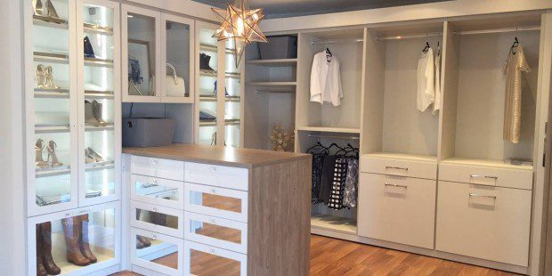 White Walk in Closet with Closet Rods Drawers and Lighted Glass Door Display Shelving