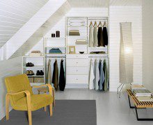 Tiered White Reach in Closet With Shelving Drawers and Metal Closet Rods
