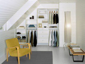 Small space reach in closet with custom shelves, drawers and hanging racks