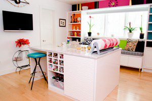 Colorful Craft Room with White High Gloss Shelving Cabinets Built in Window Seating and Stand Alone Workspace