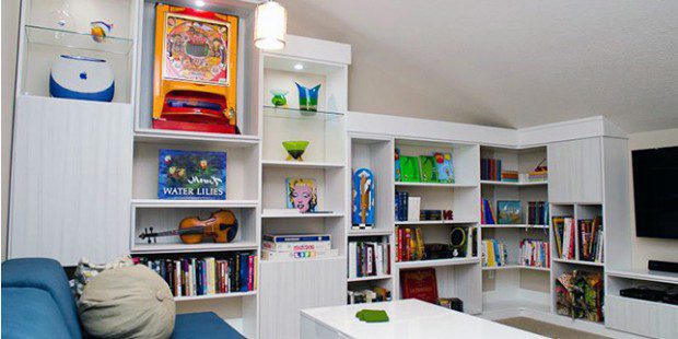 Redesigned Loft Space with White Shelving Cabinets Entertainment Center Built in Lighting and High Gloss Coffee Table