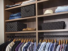 Erica Coffman Client Story Close up of Dark Brown Reach in Closet Shelving And Hanging Clothes