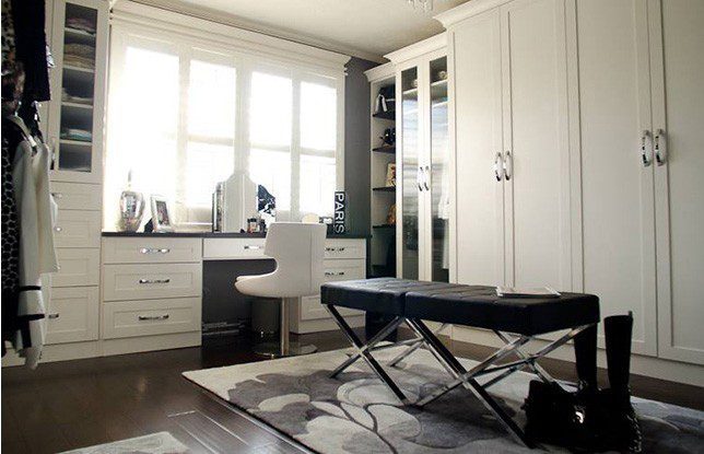 White Walk in Closet with Wardrobe Built in Desk Cabinets with Glass Doors and Black Stand Alone Bench