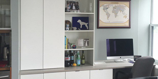 Office with White shelving Drawers Cabinets and Grey Topped Built in Desk