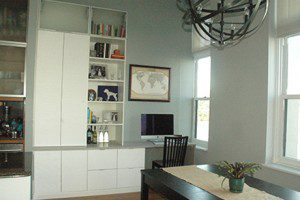 Office Nook with White shelving Drawers Cabinets and Grey Topped Built in Desk