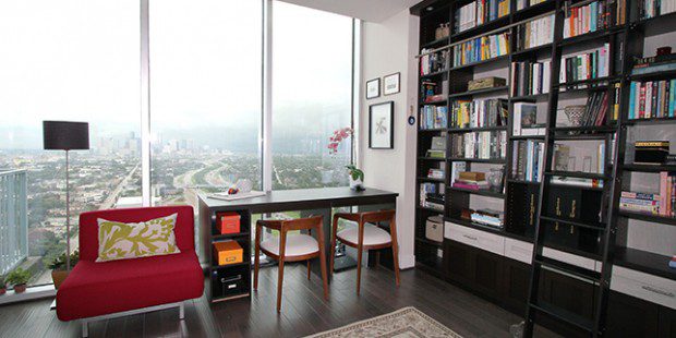 Office Library with Black Stand Alone Desk Built in Shelving and Rolling Latter and High Gloss White accent Drawers