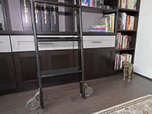 Close Up of Sliding Black Library Ladder and High Gloss White Accent Drawers