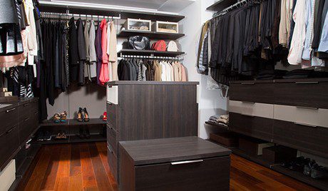 Dark Brown Walk in Closet with Shelving Closet Rods Floor Level Cubbies and Stand Alone Tiered Dresser