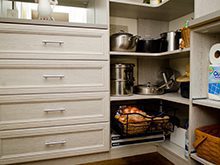 Close up of White Wood Grain Pantry Storage With Drawers Shelving and Pull out Metal baskets