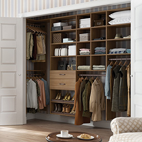 Dark Wood Reach in Closet with Closet Rods and Light Brown Drawers and Shelving