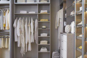 Walk in Closet with Grey Shelving Closet Rods Lighted Shoe Racks and White Dresser Drawers