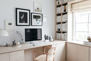 Modern Office for home in light wood grain finish custom cabinets and bookshelf California Closets.