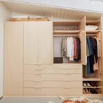 Reach in closet drawers design for bedroom in natural wood grain finish by California Closets