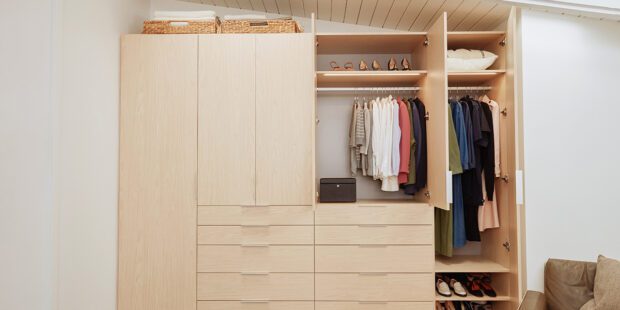 Reach in closet drawers design for bedroom in natural wood grain finish by California Closets