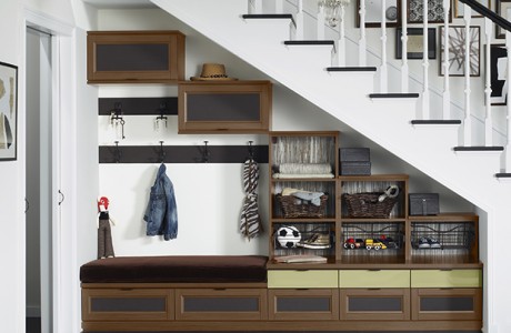 Built in entryway storage hallway systems in dark wood grain finish with cubbies, cabinets and built in seating by California Closets