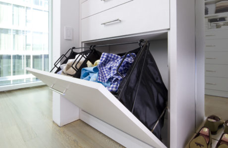 Built in dresser with tilt down drawer and metal baskets closet organizers by California Closets