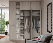 Closet organization to promote stress free storage solutions shown in light grey cabinets and shelving design by California Closets