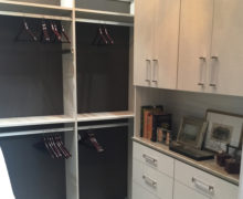 Close Up Image of Walk in Closet with Closet Rods Cabinets and Dresser Drawers