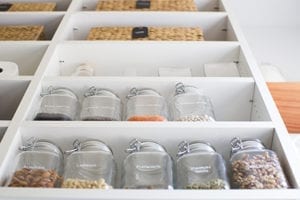 Close up Image of White Pantry Shelving With Mason Jars