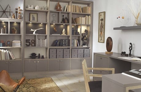 Office Space with Grey Shelving Cabinets L Shaped Desk Built in Lighting and Light Wood Accents