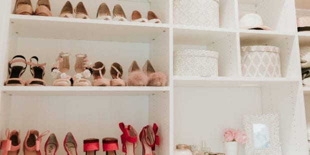 White shelving displaying colorful high heels and hat boxes in the new closet for California Closets client Erika Altes