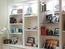 White shelving displaying pictures and other niche items