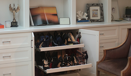 Pull out custom shelving reveals hidden shoe storage