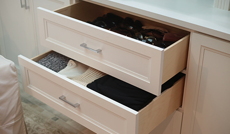 Light tan drawers out to reveal folded shirts