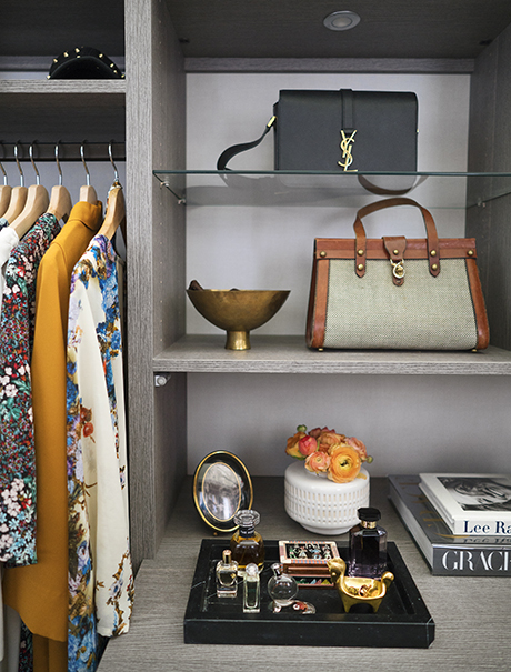 Light grey woodgrain shelving displaying purses and perfume for California Closets client Anna Bond