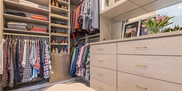 Men's shirts and accessories organized in light tan custom shelving