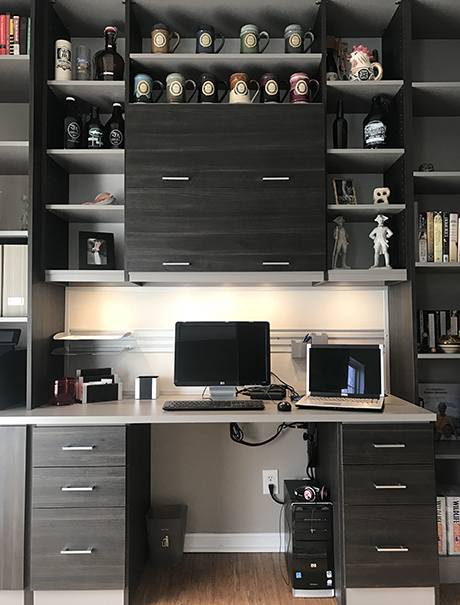 Dark grey wooden work space with laptop and shelving for coffee mug collection