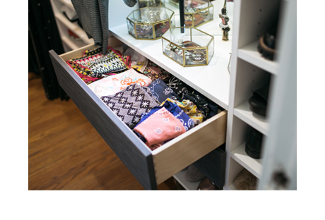 Colorful scarves folded up in a pull out drawer