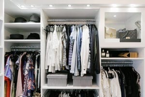 An organized closet with clothes and accessories for client Kimberly Lapides