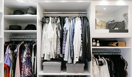 An organized closet with clothes and accessories for client Kimberly Lapides