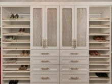 Tan and gold wardrobe with slanted shoe shelves in California Closets client Jenny Lee's new closet