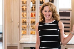 California Closets client Jill K smiling in her new elegant walk in closet