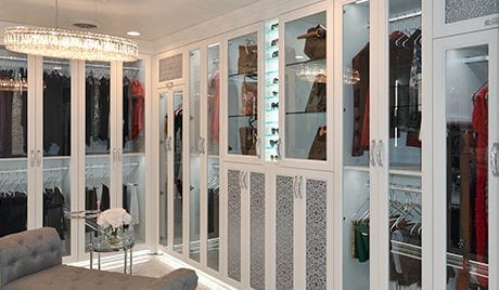 California Closets Michelle Mangini Client Story white glass cabinets bags and clothing