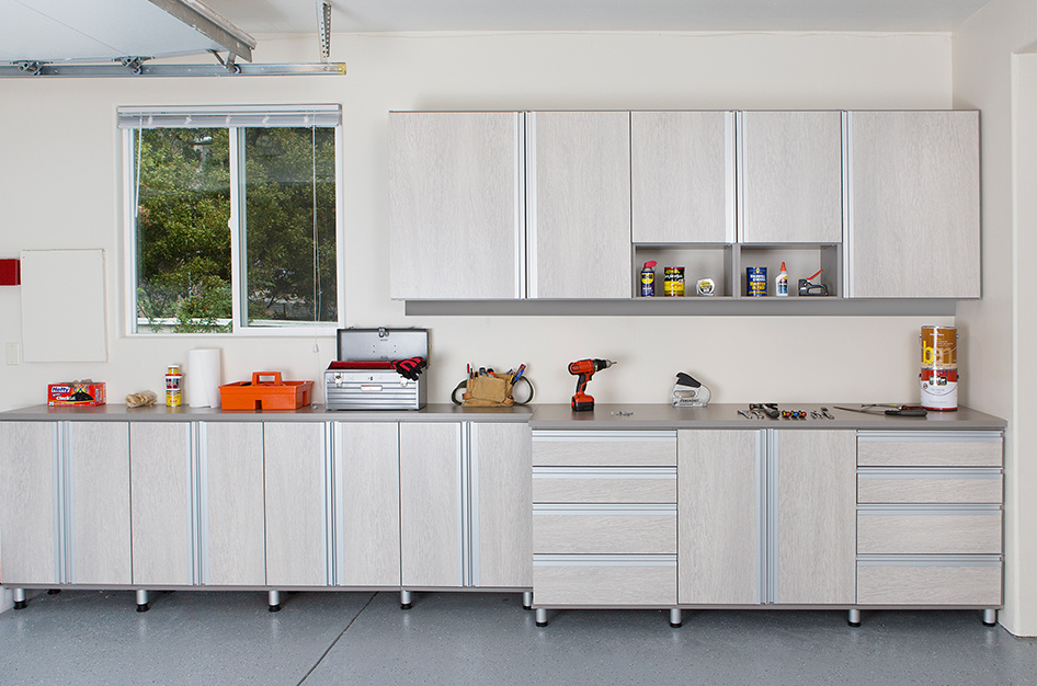 Custom garage storage in with cabinet storage, drawers and shelving.Created and designed by California Closets.