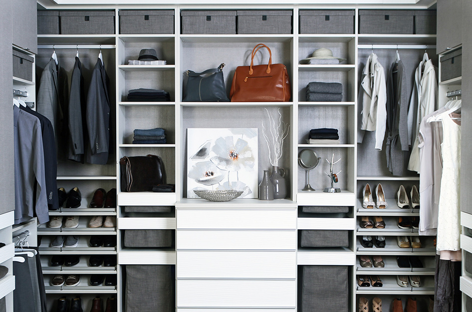 Furnished interior closet with shelving for hats, shoes, purses, and coats.