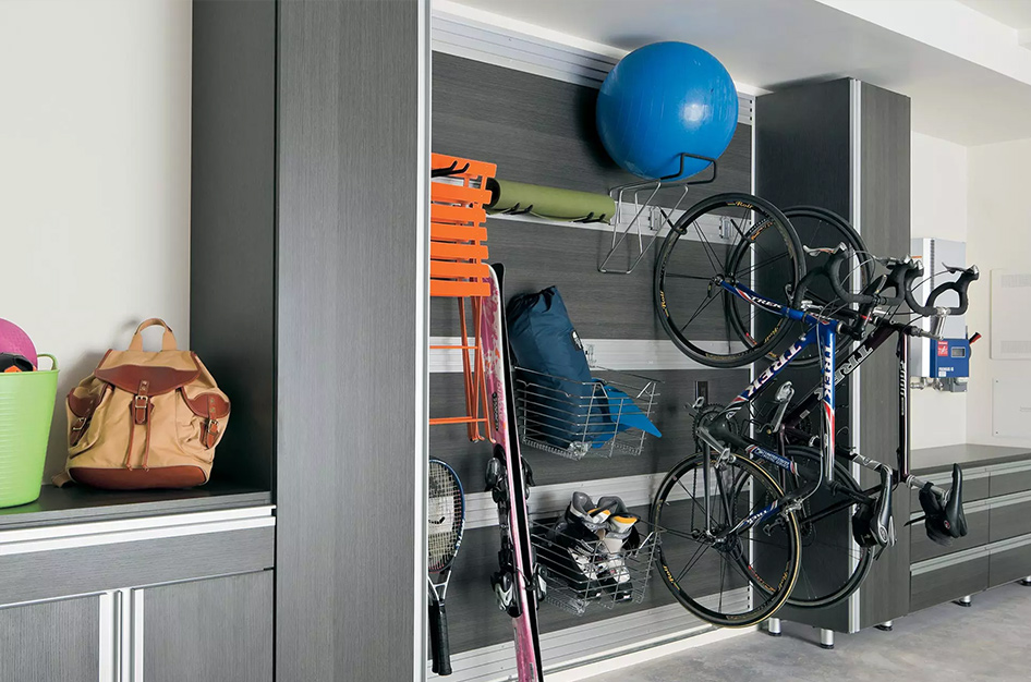 Garage cabinetry with racks for hanging bikes, snowboards, and other outdoor equipment.