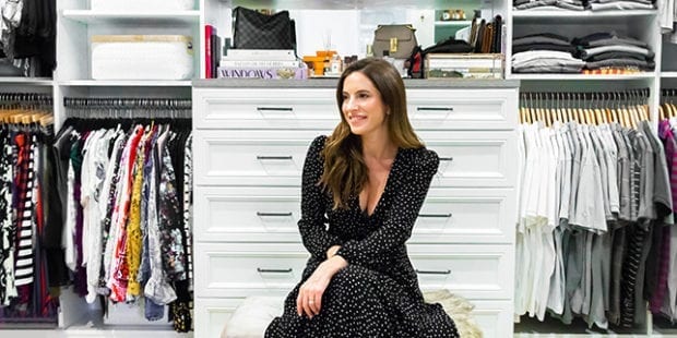 On-screen personality Jami Krell sitting in her custom walk-in closet