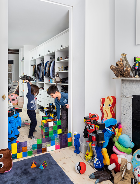 Playful kid's closet design with shelving, drawers and toy storage in white wood grain finish created by California Closets