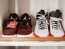 Slanted shoe shelves displaying tennis shoes
