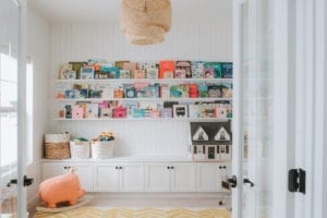 Classic white playroom with organized bookshelf for photographer Sydney Gerten